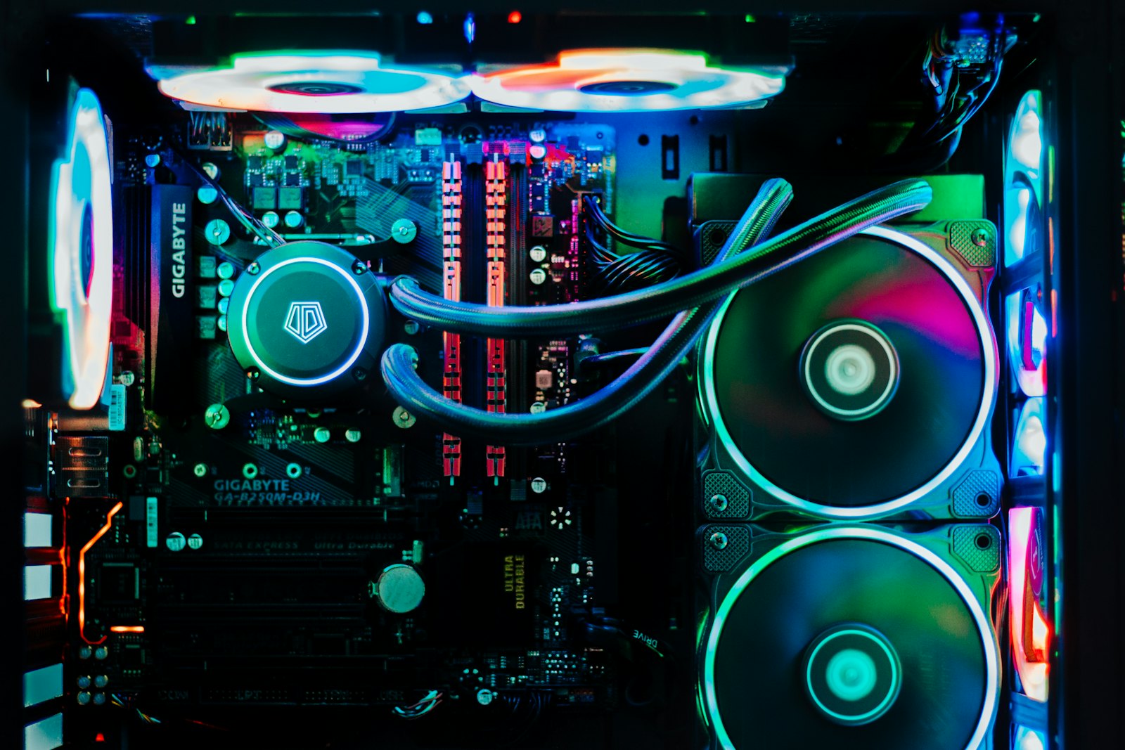 A close-up of a computer motherboard, lit from below in a dark room