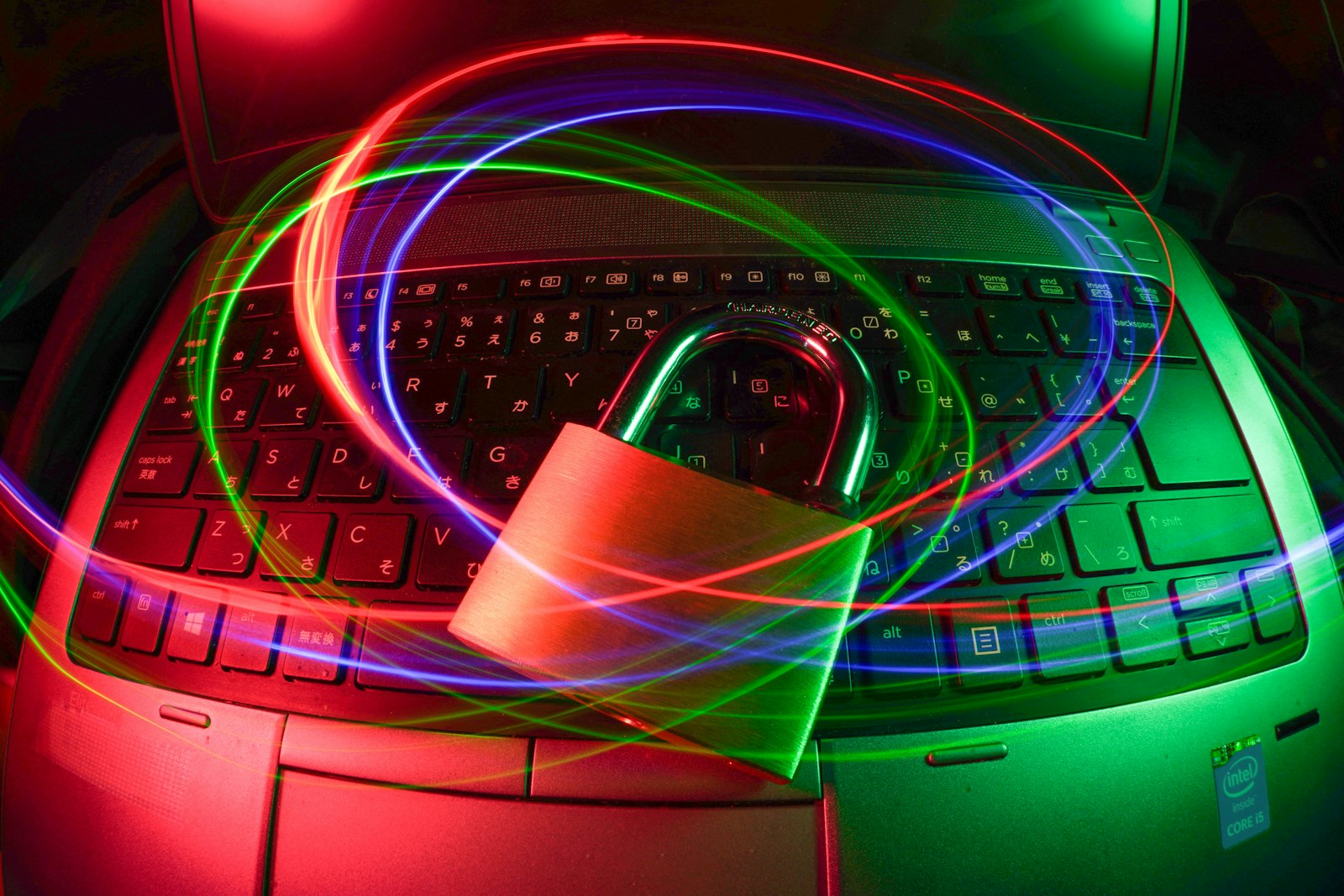 A padlock on a laptop with streaks of light around it